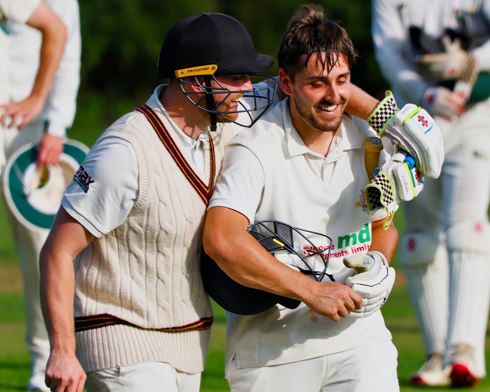 Two cricketers at the end of a game.
