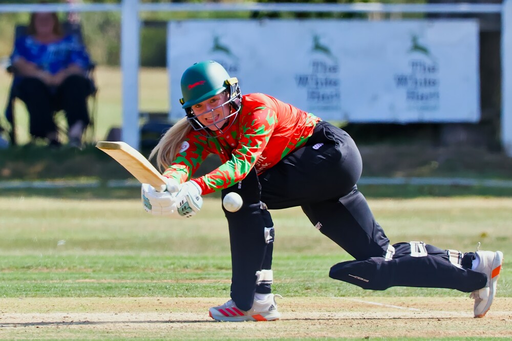 A cricketer hitting the ball.