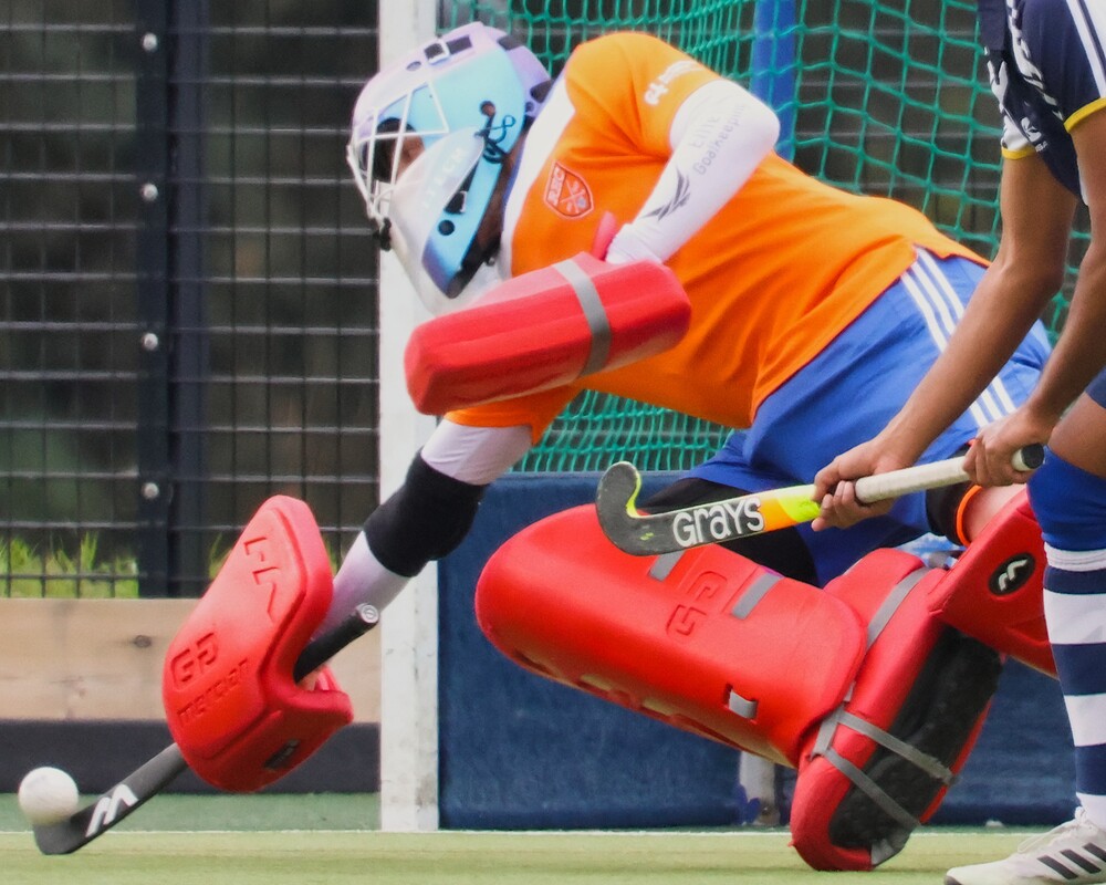 A hockey goalkeeper making a save.